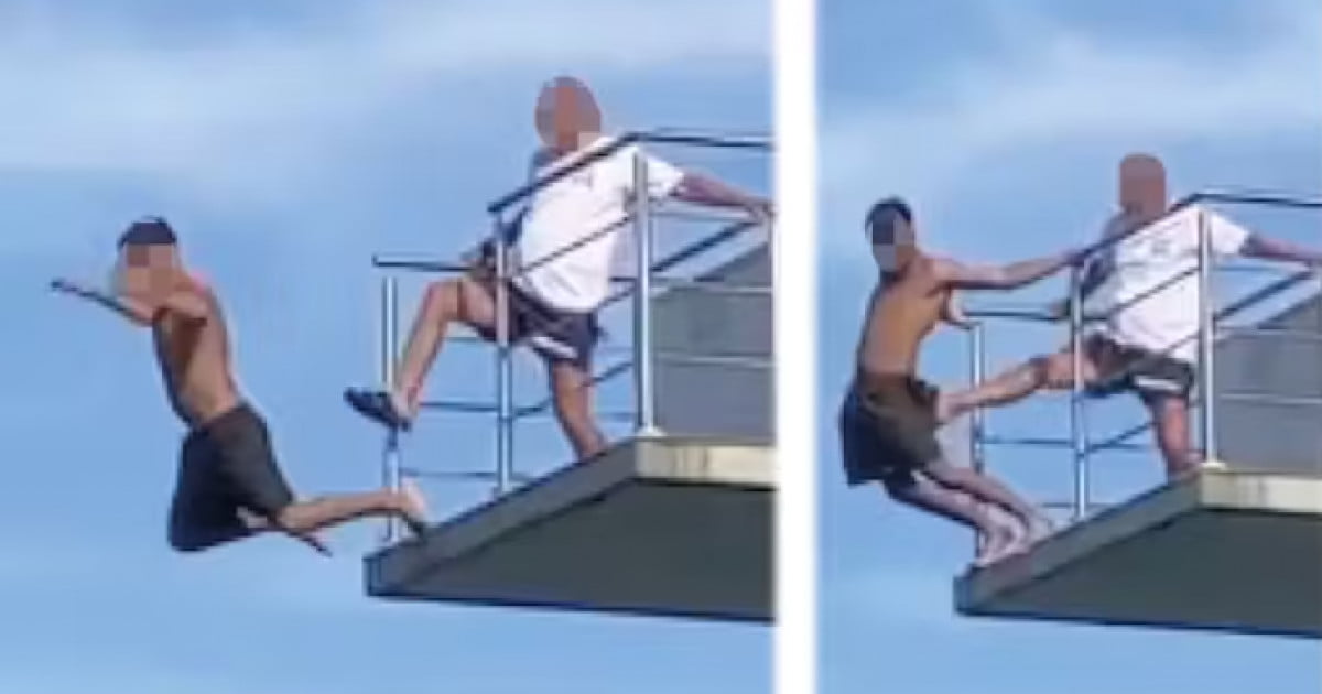 Momentul șocant în care un salvamar împinge cu piciorul un tânăr în bazin de pe o platformă înaltă de 10 metri
